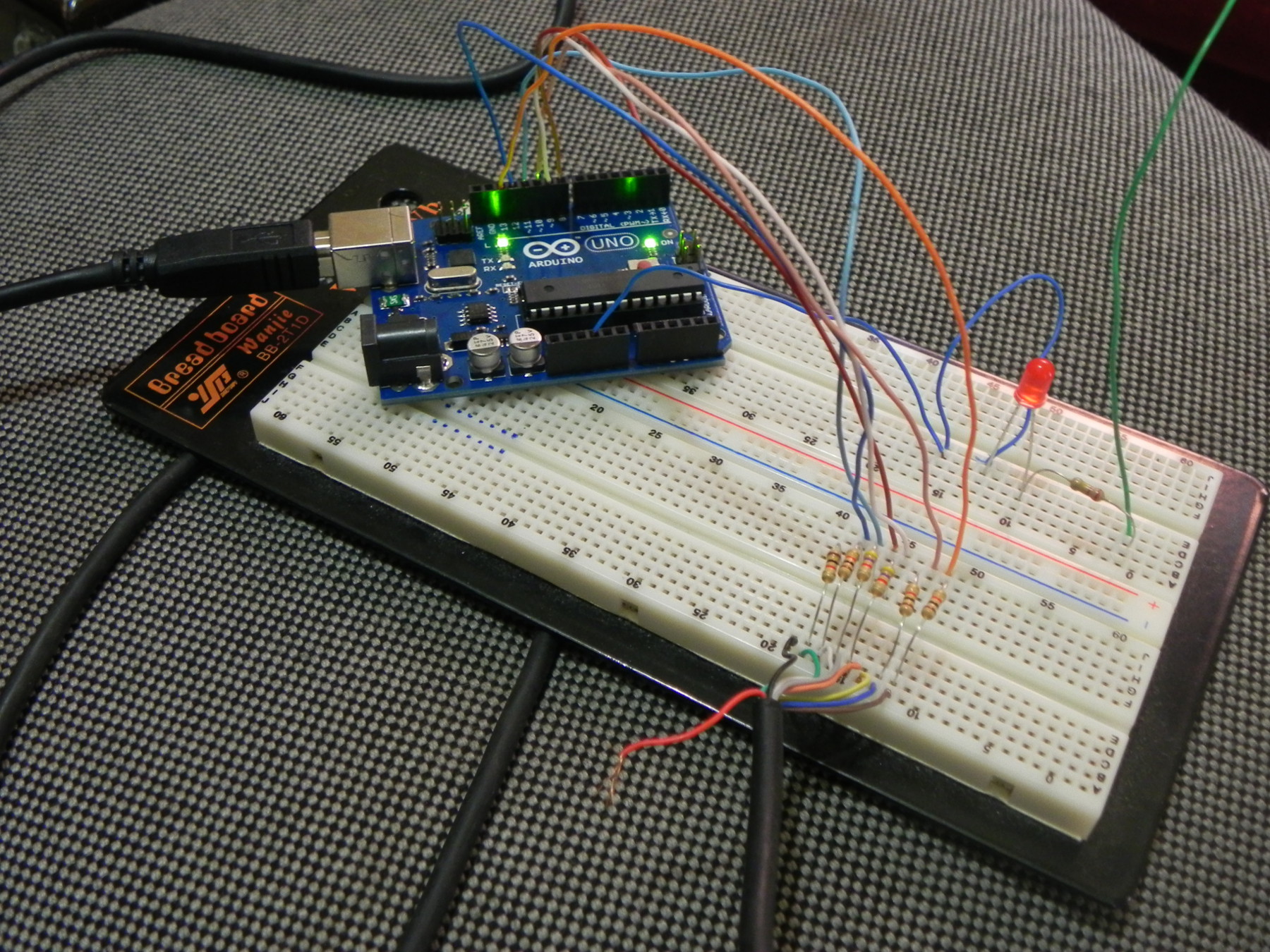 An arduino board connected to a breadboard